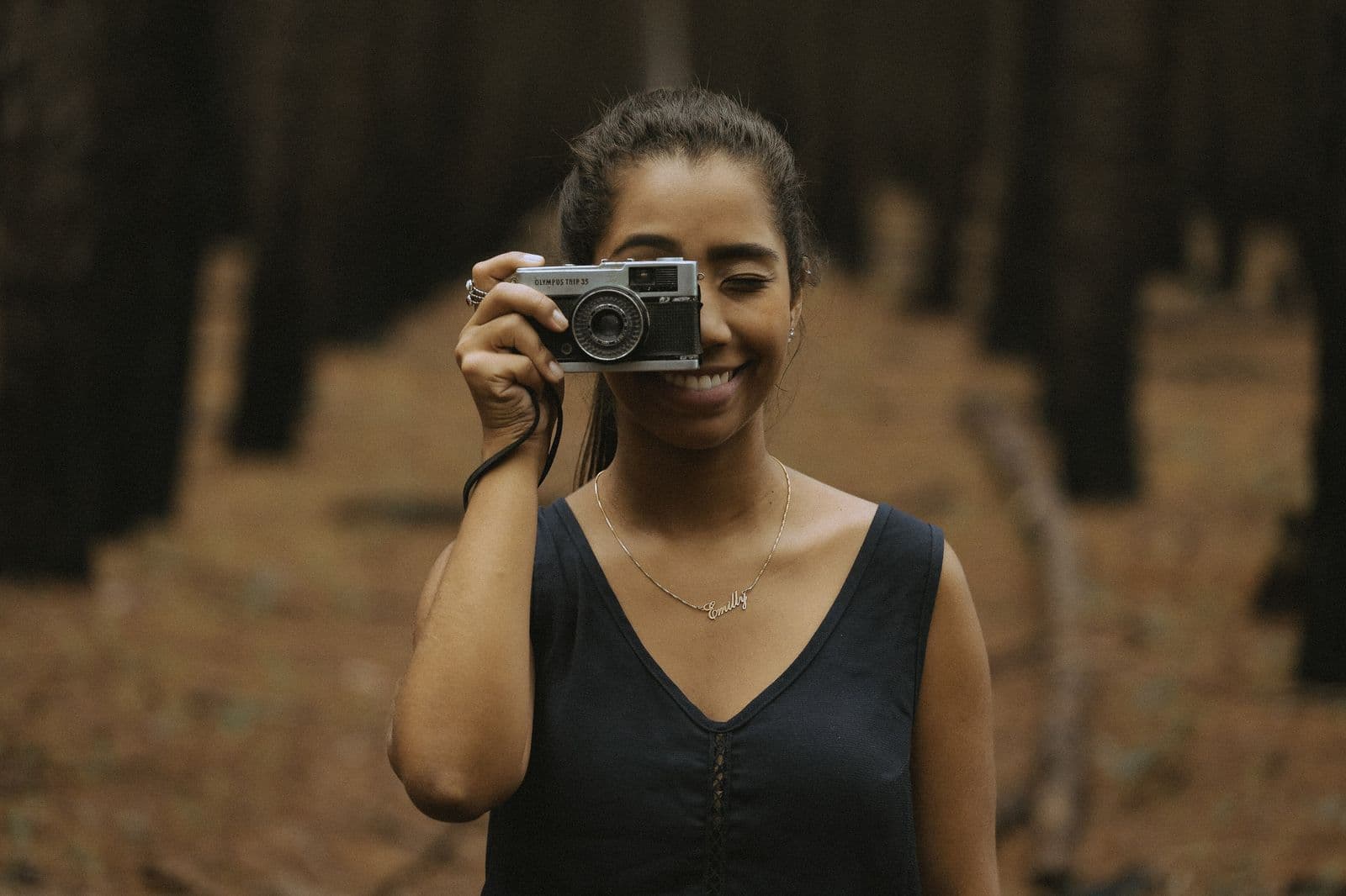 A photographer smiling behind her camera